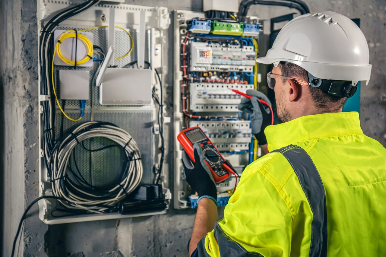 man-an-electrical-technician-working-in-a-switchboard-with-fuses-1-1